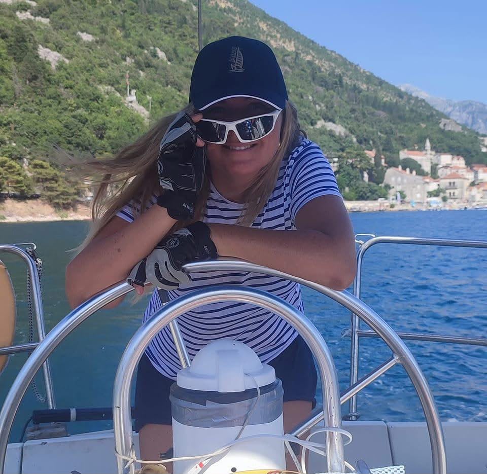 Skipper at the wheel in the Bay of Kotor